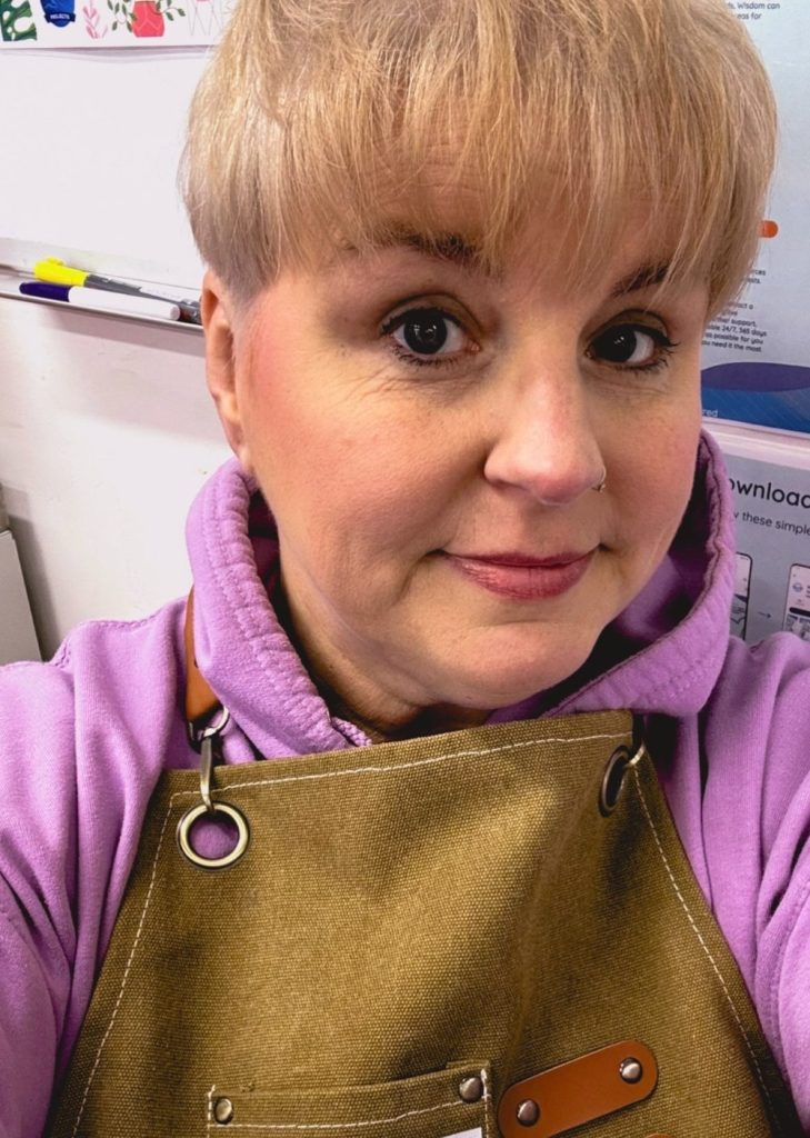 Person wearing apron and hoodie