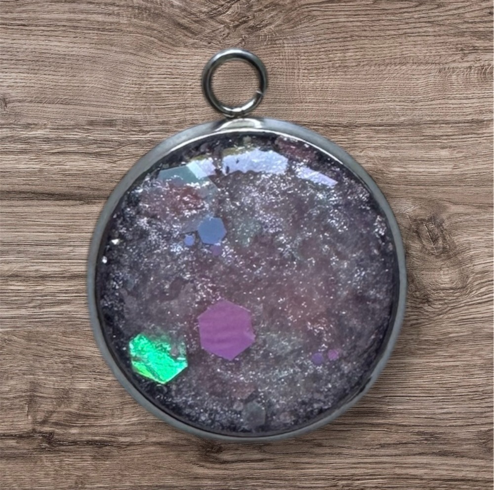 Colorful geode pendant on wood