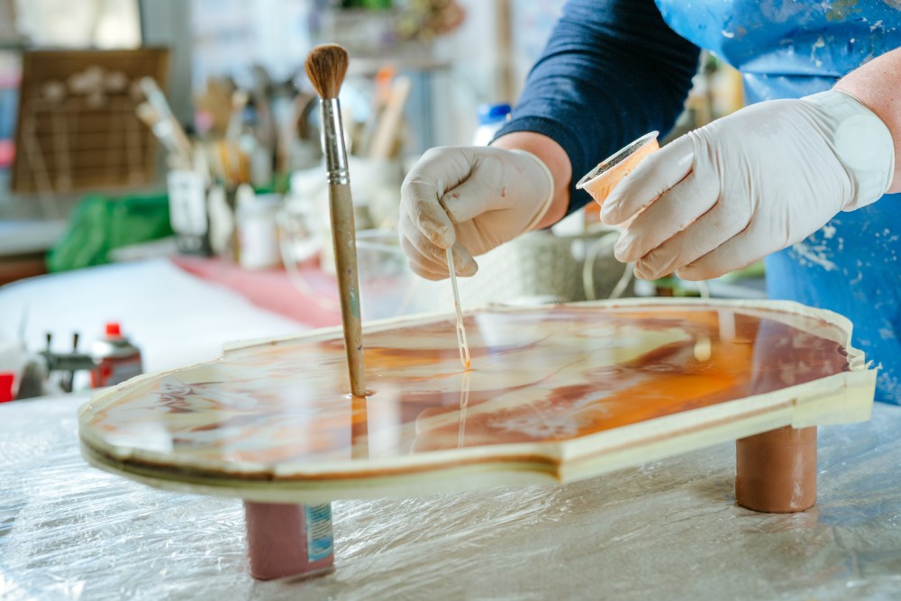 Artist applying epoxy resin